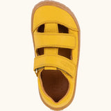 Top view of Froddo natural leather barefoot children's sandal in yellow showing the 2 velcro strap fastener and insole detail