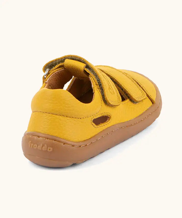 Back of the Froddo natural leather barefoot children's sandal in yellow showing the padded ankle support and brown rubber sole