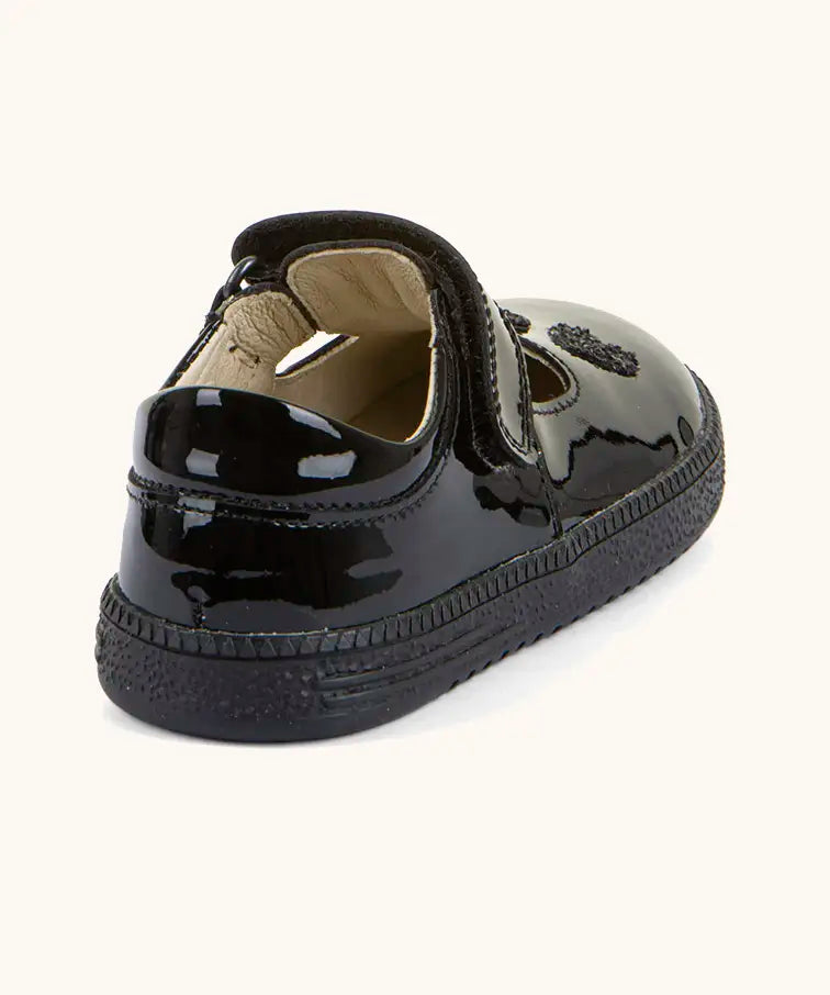 Back of Froddo barefoot kids school shoe in black patent material showing padded ankle support