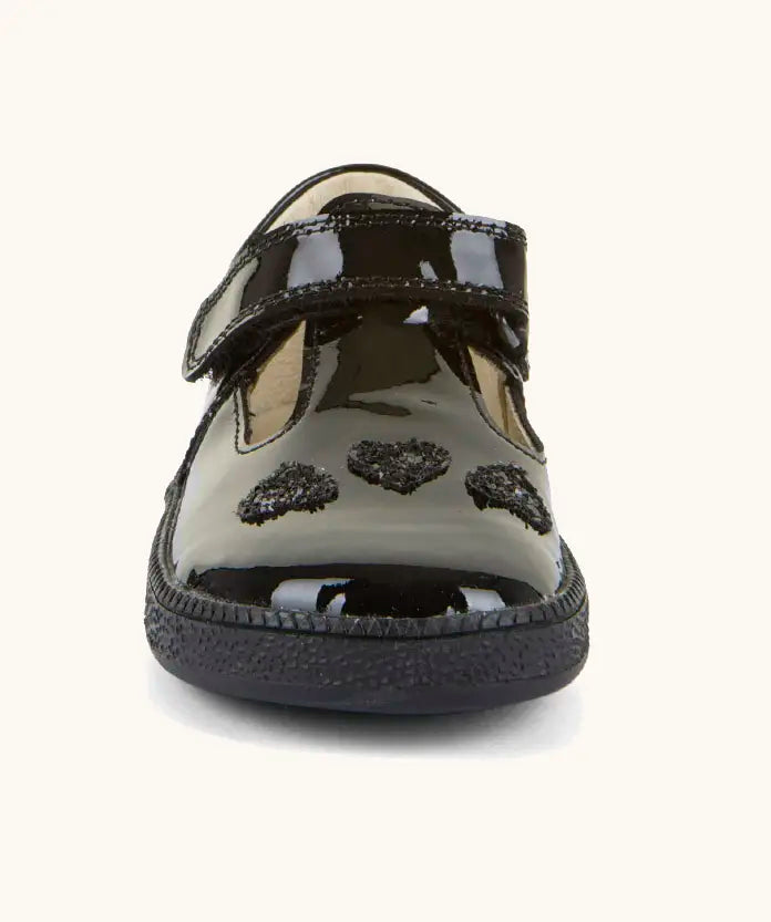 Front of Froddo barefoot kids school shoe in black patent material showing t-bar velcro and heart decration.