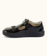Side of Froddo barefoot kids school shoe in black patent material showing t-bar velcro fastener looped through eyelet
