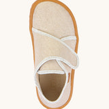 A top down image of the Froddo barefoot kids slipper in gold shine available at Babipur. showing the velcro strap and insole detail
