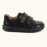 Side of Froddo barefoot school shoe in black with 2 front velcro straps and a padded ankle support
