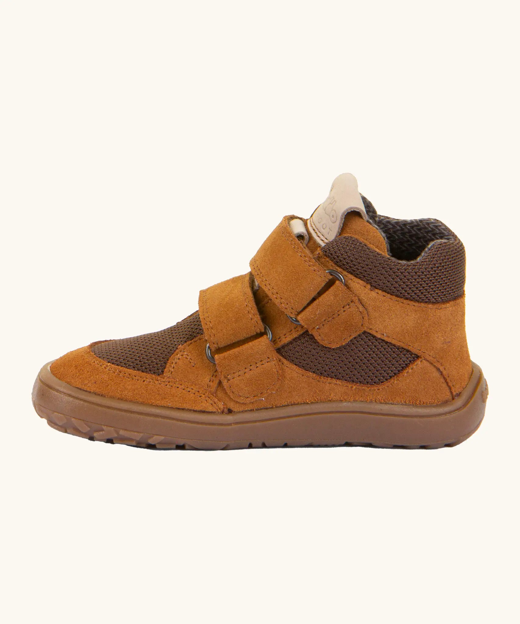 Side of the rusty brown Froddo barefoot kids suede TEX shoes showing padded ankle support and velcro straps looped through the eyelets