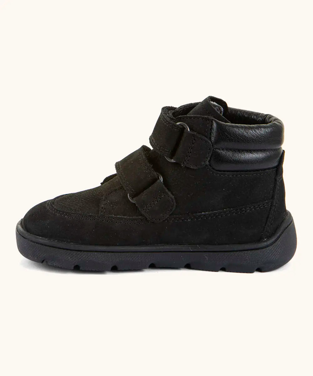 Side of Froddo barefoot Zuru tex kids shoe in black. A natural leather shoe with 2 velcro fastener looped through eyelets