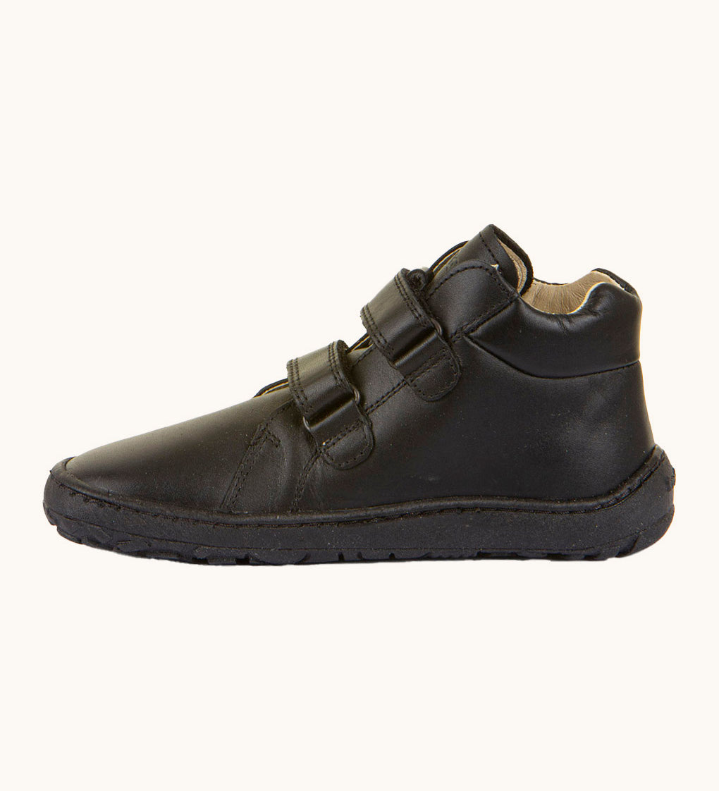 Froddo barefoot leather school boots in black available at Babipur. Showing the veclro strap detail trough the loops. 