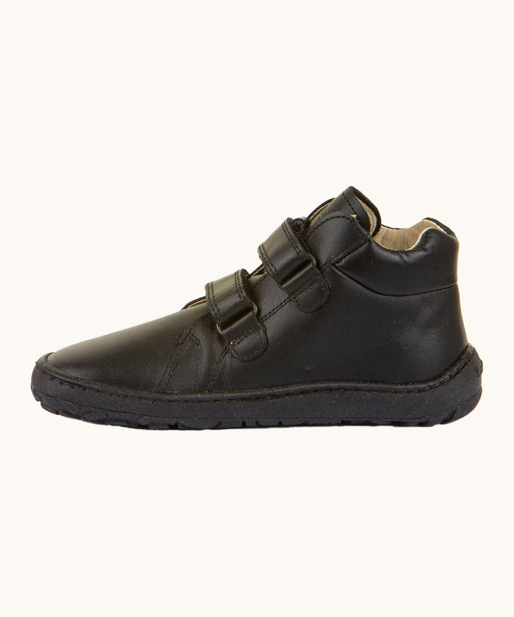 Froddo barefoot leather school boots in black available at Babipur. Showing the veclro strap detail trough the loops. 