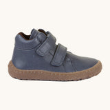 A side image of a Froddo barefoot Autumn children's shoe in navy available at Babipur showing the 2 velcro fastener padded ankle support and the dark brown grippy sole detail