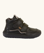 Side of Froddo barefoot tex kids autumn natural leather ankle school boots in black showing Velcro straps fully fastened and brown flexible rubber sole