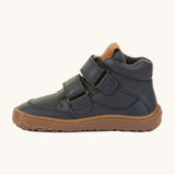 A side image of a Froddo barefoot Autumn children's shoe in navy available at Babipur showing the 2 velcro fastener for a secure fit, padded ankle and the dark brown grippy sole