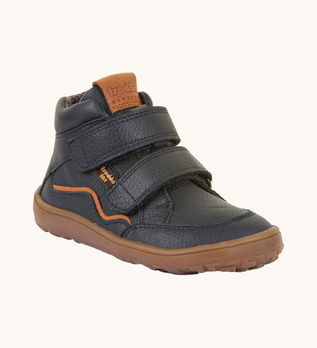 Froddo barefoot tex kids autumn shoes in navy available at Babipur. A soft ankle high shoe in navy with a light brown rubber sole. Features two velcro straps for a secure fit 