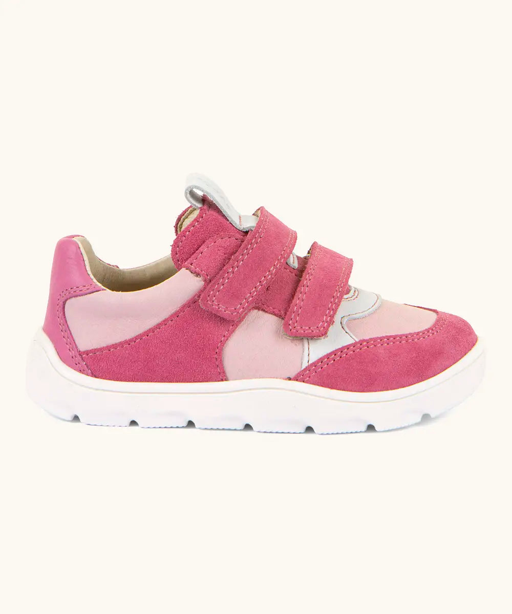 Side of Froddo barefoot zeru Spring kids shoes in bright and dark pink Showing 2 pink velcro fasteners, pull tab on tongue and white grippy sole