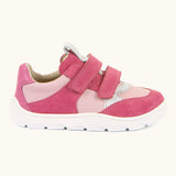 Side of Froddo barefoot zeru Spring kids shoes in bright and dark pink Showing 2 pink velcro fasteners, pull tab on tongue and white grippy sole