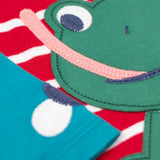 A close up of the Frugi kids alfie raglan berry red breton frog top showing the playful green frog applique detial on organic cotton fabric.