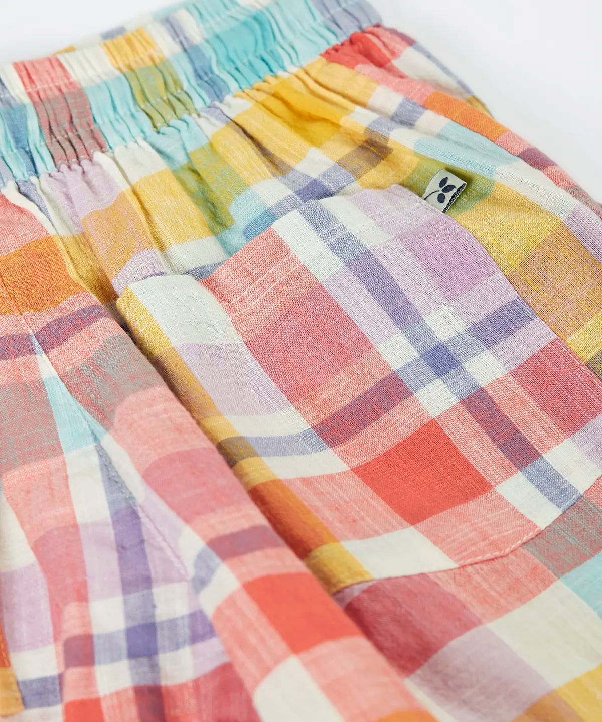 Frugi 100% organic cotton Archie slub short in a pastel check design laid flat showing a black pocket