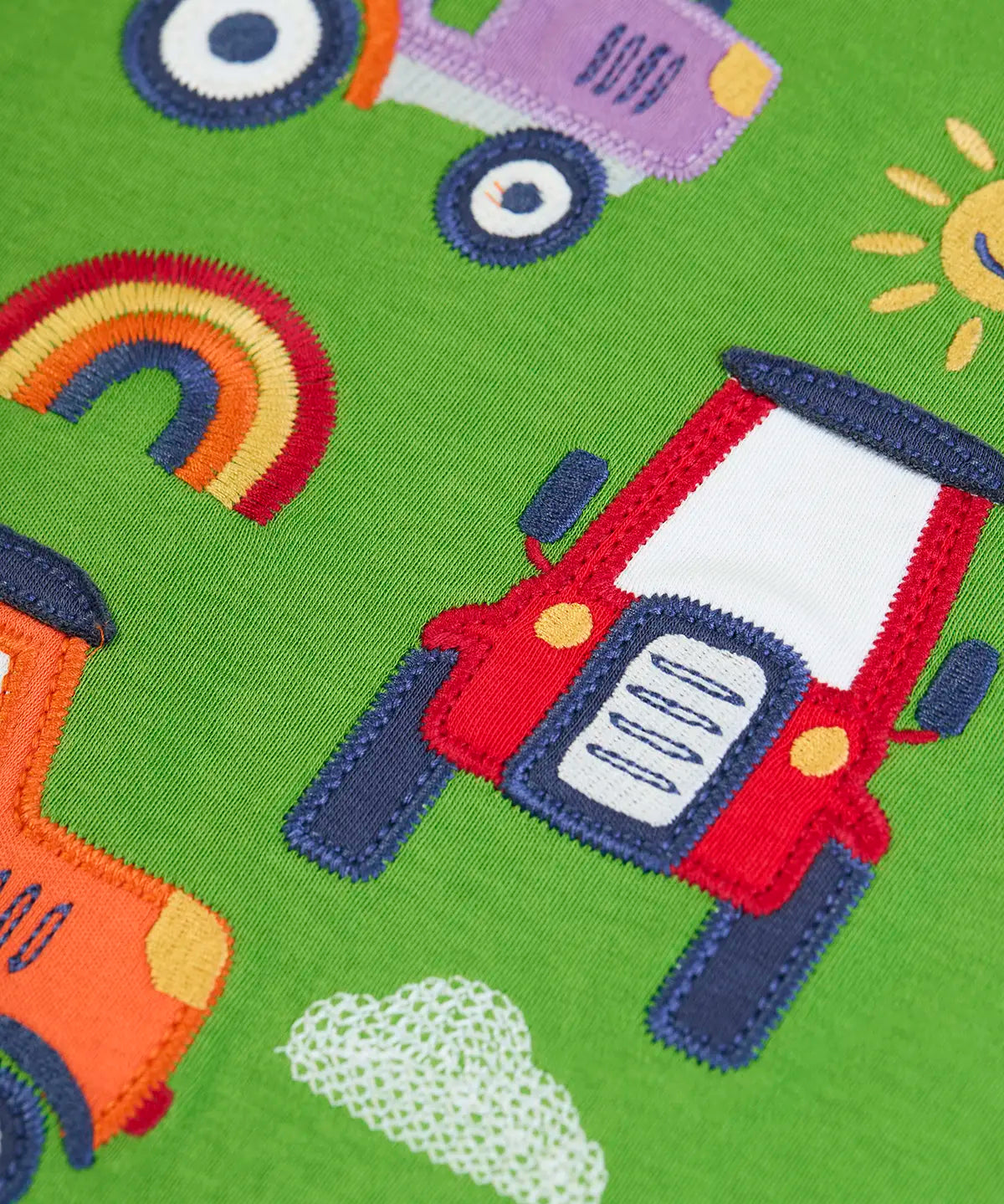 Frugi GOTS 100% organic cotton kids long sleeve top in green showing a close up of the playful tractors  appliques 