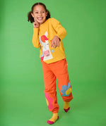 Frugi adventure top with horse applique paired with pink jogger bottoms with floral design, worn by girl.