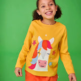 Frugi adventure yellow top with horse and stars applique worn by young girl.