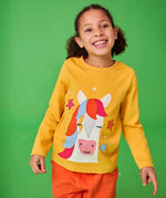 Frugi adventure yellow top with horse and stars applique worn by young girl.