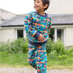 A child wearing the Frugi Malpas Joggers - Navy Alpine Adventures, and matching jumper