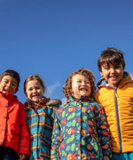 Children wearing Frugi's reversible, playtime, 3 in 1 rambler and tartan parka coats 