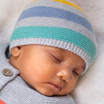 A baby wearing the Frugi Harlen Knitted Hat - Grey Marl Stripe