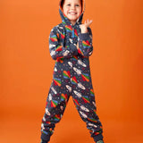 Frugi big organic cotton snuggle suit in blue with rainbow rocket and planet design, worn by child with hood up.