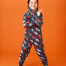 Frugi big organic cotton snuggle suit in blue with rainbow rocket and planet design, worn by child with hood up.