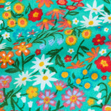 Frugi GOTS 100% organic cotton all in one hooded snuggle suit in green showing a close up of the repeating floral design 