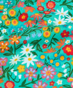 Frugi GOTS 100% organic cotton all in one hooded snuggle suit in green showing a close up of the repeating floral design 