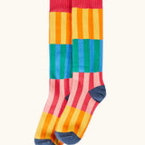 Frugi GOTS organic cotton socks showing   colourful striped design and a navy heel and toe and coral ankle cuff 