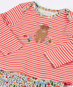 Frugi's baby all in one outfit laid flat showing close up of the cute highland cow applique on organic cotton fabric. Features a envelope neckline