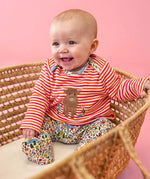 Frugi Brooke easy-dressing babygrow in pink stripes with Highland cow applique and floral footed bottoms.