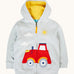 Frugi organic cotton hoodie laid flat. In light grey with a yellow inner lining. Has a red tractor on the bottom with a full length zip