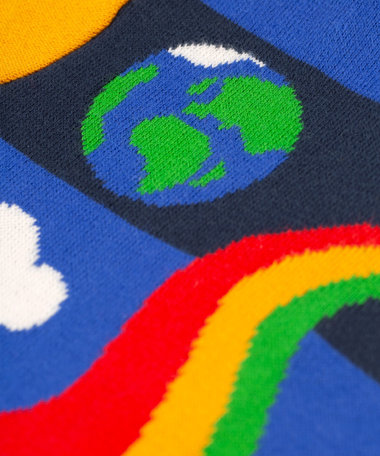 A closer look at the planet and rainbow swirl design on the Frugi Corin Knitted Cardigan - Blue Tang/Rocket Flight
