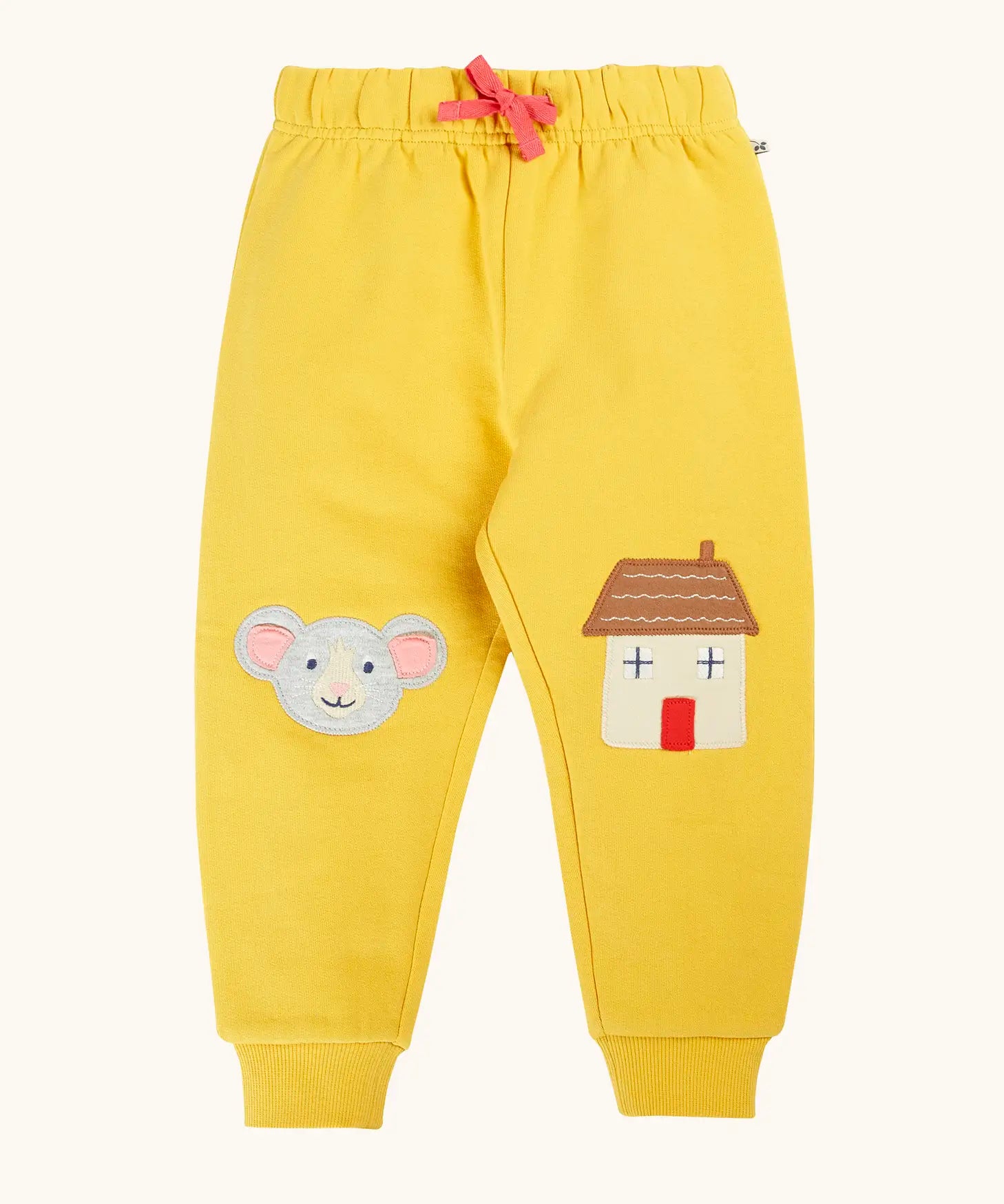 Frugi GOTS 100% organic cotton joggers in yellow with a cute mouse and house appliques on the knees. Features an elasticated wait band and pink drawcord