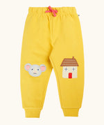 Frugi GOTS 100% organic cotton joggers in yellow with a cute mouse and house appliques on the knees. Features an elasticated wait band and pink drawcord