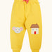 Frugi GOTS 100% organic cotton joggers in yellow with a cute mouse and house appliques on the knees. Features an elasticated wait band and pink drawcord