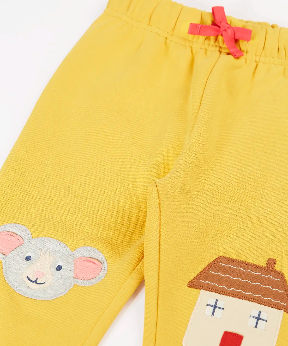Frugi kids GOTS 100% organic cotton joggers in yellow with a cute mouse and house appliques on the knees and pink drawcord