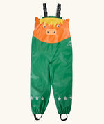 Frugi character puddle buster trousers showing a green leg and a highland cow upper body panel. Features elasticated shoulder straps