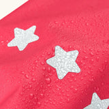 Frugi rhubarb/cat character puddle buster trousers showing water beading near the star reflective patches on the leg