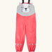 Frugi character puddle buster trousers showing a pink leg and a playful grey cat upper body panel. Features elasticated shoulder straps