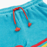 Frugi GOTS organic cotton coast towelling shorts in light blue laid flat showing the red waist cord