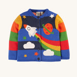 This long-sleeved Corin Knitted Cardigan from Frugi, made from soft organic cotton, In a Rocket Flight design, this cardigan has stretchy rib cuffs and button fastenings running down the front. The print has colourblock stripes, a rocket, stars, a planet and clouds, continued on the back of the cardigan.