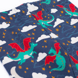 A close up of the flying green dragon print and elasticated waist band on the Frugi cosy leggings in navy/dragon skies available at Babipur.