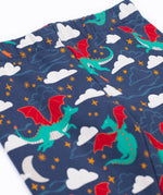 A close up of the flying green dragon print and elasticated waist band on the Frugi cosy leggings in navy/dragon skies available at Babipur.