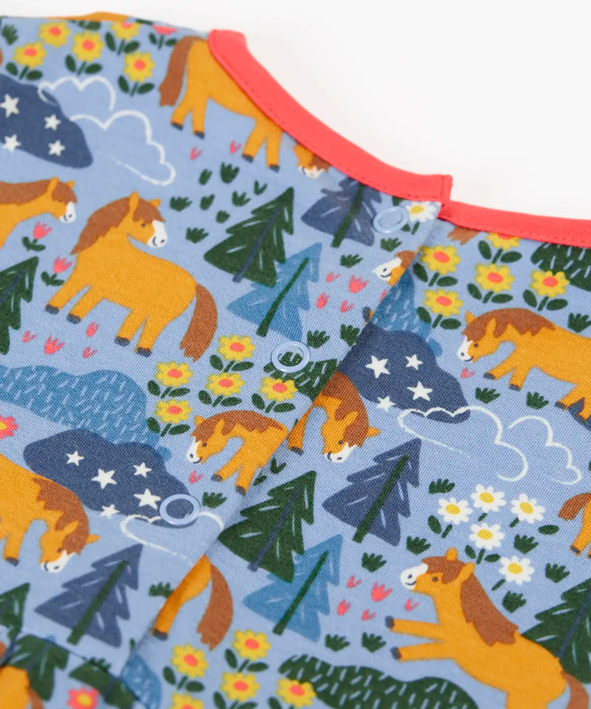 Frugi kids dress in light blue with a playful repeating shetland horse print laid flat showing popper fasteners on the back for easier dressing