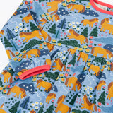 Frugi kids dress in light blue showing close up of the playful repeating shetland horse print and light pink trim on blue organic cotton fabric