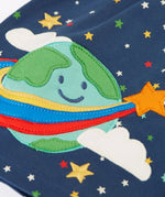 Frugi kids dress laid flat showing close up of the cute planet earth applique on the gather on navy organic cotton fabric