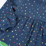 Frugi kids dress laid flat showing the repeating stars print and elasticated cuff detail on navy organic cotton fabric